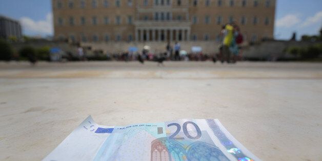 ATHENS, GREECE - JULY 06: In this photo illustration a 20 Euro note sits on the steps of the Greek Parliament on July 6, 2015 in Athens, Greece. Politicians in Europe and Greece are planning emergency talks after Greek voters rejected EU proposals to pay back it's creditors creating an uncertain future for Greece. (Photo illustration by Christopher Furlong/Getty Images)