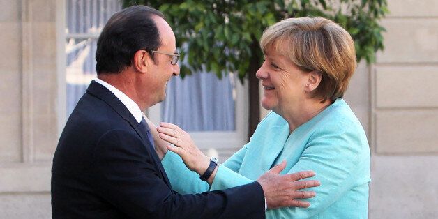 France's President Francois Hollande, left, welcomes German chancellor Angela Merkel prior to a meeting, at the Elysee Palace, in Paris, France, Monday, July 6, 2015. German Chancellor Angela Merkel has arrived at the Elysee Palace for talks with French President Francois Hollande about the Greek crisis. The two are expected to issue a joint statement that's likely to reflect the line to be taken at the summit. France has appeared more conciliatory than Germany toward Greece over the past few months of protracted bailout discussions. (AP Photo/Thibault Camus)
