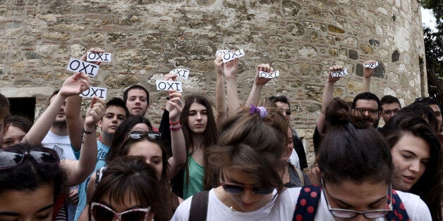 Members of the youth wing of the governing radical left Syriza party hold papers calling for a ''No'' vote in the referendum