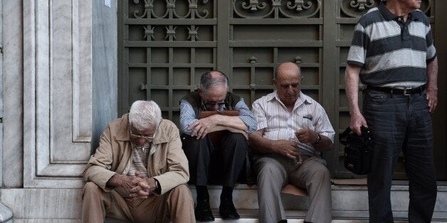 Pensioners wait outside a national bank brunch, as banks only opened for pensioners to allow them to get their pensions, with