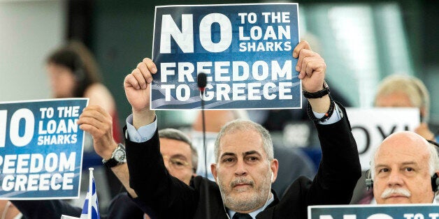 Far-right E.U Parliament members display posters before Greek Prime Minister Alexis Tsipras delivers his speech at the European Parliament in Strasbourg, eastern France, Wednesday, July 8, 2015. Tsipras says his country wants a deal that will mean a definitive end to Greeceâs protracted financial crisis, and that last Sundayâs referendum result does not mean a break with Europe. (AP Photo/Jean-Francois Badias)