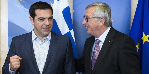 Greece's Prime Minister Alexis Tsipras (L) is welcomed by European Commission President Jean-Claude Juncker (R) ahead of a meeting on Greece, at the European Commission in Brussels,on June 24, 2015, as eurozone finance ministers try to finalise a debt deal and avoid a default by Athens. Greek Prime Minister Alexis Tsipras is set to conduct yet another round of crisis talks with representatives of the country's creditors, ahead of a crucial meeting of eurozone finance ministers where all sides hope a solution can be found to save the country from bankruptcy. AFP PHOTO/POOL JULIEN WARNAND (Photo credit should read JULIEN WARNAND/AFP/Getty Images)