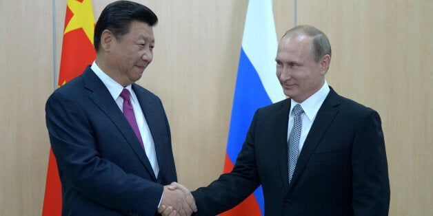 UFA, RUSSIA - JULY 8: In this handout image supplied by Host Photo Agency / RIA Novosti, President of the Russian Federation Vladimir Putin (R) meets with President of the People's Republic of China Xi Jinping in Ufa during the BRICS/SCO Summits - Russia 2015 on July 08, 2015 in Ufa, Bashkortostan, Russia. (Photo by Sergey Guneev/Host Photo Agency/Ria Novosti via Getty Images)