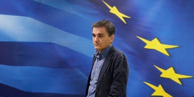 New Greek Finance Minister Euclid Tsakalotos arrives for a hand over ceremony in Athens, Monday, July 6, 2015. Following Sunday's referendum the Greece and its membership in Europe's joint currency faced an uncertain future Monday, with the country under pressure to restart bailout talks with creditors as soon as possible after Greeks resoundingly rejected the notion of more austerity in exchange for aid. (AP Photo/Petr David Josek)