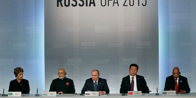From left: Brazil's President Dilma Rousseff , Indian Prime Minister Narendra Modi, President of Russia Vladimir Putin, President of China Xi Jinping and South African President Jacob Zuma sit during a signing ceremony at the BRICS Summit in Ufa, Russia, Thursday, July 9, 2015. Ufa is hosting BRICS (Brazil, Russia, India, China and South Africa) and SCO (Shanghai Cooperation Organisation) summits. (Sergei Ilnitsky/Pool photo via AP)