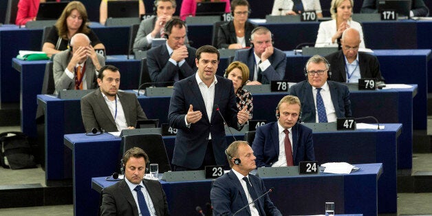 Greek Prime Minister Alexis Tsipras, standing at center, delivers hi speech at the European Parliament in Strasbourg, eastern France, Wednesday, July 8, 2015. Tsipras earned both cheers and jeers as he addressed lawmakers at the European Parliament, where he said his country is seeking a deal that might bring a definitive end to his country's financial crisis, not just a temporary stop-gap.(AP Photo/Jean-Francois Badias)