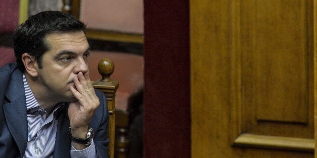 Greek Prime Minister Alexis Tsipras takes part at a joint session of four committees of the Parliament (Economic, Social, Public Administration and Production and Trade) at the Greek Parliament in Athens on July 10, 2015. Lawmakers in Greece are to vote whether to back a last-ditch reform plan the government submitted to creditors overnight in a bid to stave off financial collapse and exit from the Eurozone. Greece's international creditors believe its latest debt proposals are positive enough to be the basis for a new bailout worth 74 billion euros, an EU source said June 10. AFP PHOTO/ANDREAS SOLARO (Photo credit should read ANDREAS SOLARO/AFP/Getty Images)