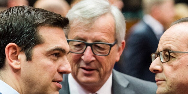 Greek Prime Minister Alexis Tsipras, left, speaks with European Commission President Jean-Claude Juncker, center, and French President Francois Hollande during a meeting of eurozone heads of state at the EU Council building in Brussels on Sunday, July 12, 2015. Skeptical European creditors raced Sunday to narrow differences both among themselves and with Athens, aiming to come up with a tentative agreement to stave off an immediate financial collapse in Greece that would reverberate across the continent. (AP Photo/Geert Vanden Wijngaert)