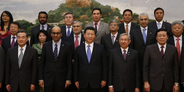 BEIJING, CHINA - OCTOBER 24: Chinese President Xi Jinping (C) poses at a meeting of reprentatives at the signing ceremony for the Asian Infrastructure Investment Bank at the Great Hall of the People on October 24, 2014 in Beijing, China. Twenty-one countries including China, India, Pakistan and Singapore had been expected to sign the agreement today establishing the $57 billion bank. A number of other Asian nations including South Korea, Indonesia and Australia declined to sign on for the time being reportedly under lobbying by the U.S. government. (Photo by Takaki Yajima-Pool/Getty Images)