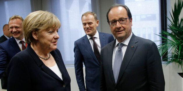 German Chancellor Angela Merkel, center left, speaks with French President Francois Hollande, center right, during a meeting on the sidelines of a eurozone heads of state summit at the EU Council building in Brussels on Tuesday, July 7, 2015. Heads of state in the eurogroup meet in Brussels on Tuesday for a special summit to discuss the financial crisis with Greece. (Olivier Hoslet/Pool Photo via AP)