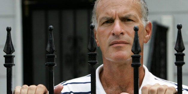DePaul University professor Norman Finkelstein looks over a fence outside his home in Chicago, Wednesday, Sept. 5, 2007. Fink