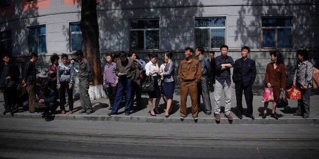 North Koreans wait in line for a city trolley, Monday, May 4, 2015 in Pyongyang, North Korea. The city trolley is one of the