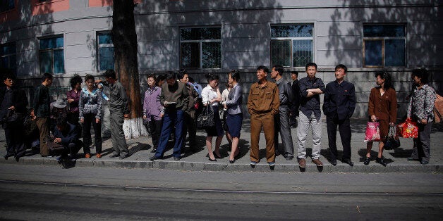 North Koreans wait in line for a city trolley, Monday, May 4, 2015 in Pyongyang, North Korea. The city trolley is one of the more common modes of public transportation used by commuters to get around the city. (AP Photo/Wong Maye-E)