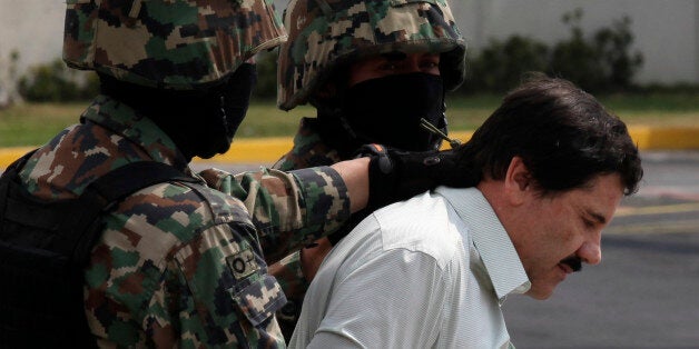 FILE - In this Feb. 22, 2014, file photo, Joaquin "El Chapo" Guzman, in handcuffs, is escorted to a helicopter by Mexican navy marines in Mexico City, Mexico. Mexico's security commission has announced early Sunday July 12, 2015 that Guzman has escaped from a maximum security prison for the second time. The commission said a search operation was being set into motion in the surrounding area and flights have been suspended at Toluca airport near the penitentiary outside Mexico City.(AP Photo/Dario Lopez-Mills, file)