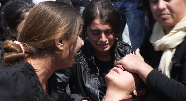 A young Yazidi women suffers a post traumatic collapse during a protest in a camp for displaced people