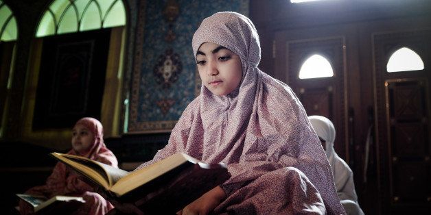 Young Bahraini Shiite Muslim girls read the Koran, Islam's holy book, during the holy fasting month of Ramadan at a mosque in the village of Sanabis, west of Manama, on July 27, 2013. AFP PHOTO/MOHAMMED AL-SHAIKH (Photo credit should read MOHAMMED AL-SHAIKH/AFP/Getty Images)