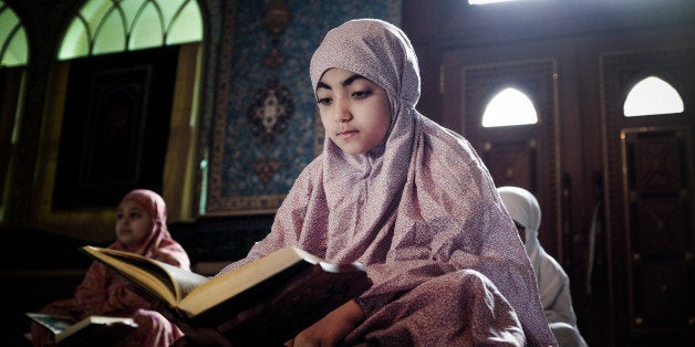 Young Bahraini Shiite Muslim girls read the Koran, Islam's holy book, during the holy fasting month of Ramadan at a mosque in
