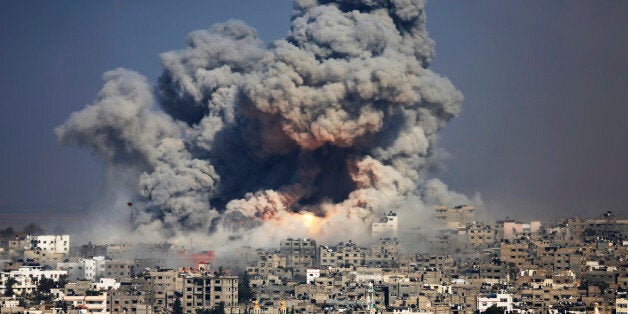 FILE - In this July 29, 2014 file photo, smoke and fire from an Israeli strike rise over Gaza City. Israel launches a pre-emptive assault on an upcoming U.N. report into last year's war in the Gaza Strip, saying it is hopelessly biased and issuing its own report that places the blame for heavy civilian casualties on Gazaâs Hamas militant rulers. The diplomatic offensive sets the stage for what is expected to be a contentious showdown with U.N. officials over allegations that Israel committed war crimes during the 50-day war. (AP Photo/Hatem Moussa, File)