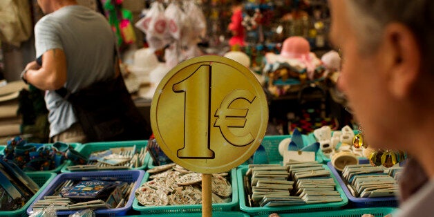 People buy items for one euro at a store in central Athens, Thursday, July 16, 2015. Greeceâs troubled left-wing government is seeking urgent relief from European lenders on Thursday, after it pushed a harsh austerity package thought parliament, triggering a revolt in the ruling party and violent demonstrations in central Athens. (AP Photo/Emilio Morenatti)