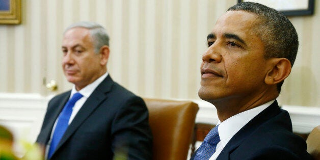 President Barack Obama and Israeli Prime Minister Benjamin Netanyahu wait for reporters and cameramen to get in place before they make statements in the Oval Office of the White House in Washington, Monday, Sept. 30, 2013. The White House said the two leaders would discuss negotiations with the Palestinians, developments in Syria and Iran. (AP Photo/Charles Dharapak)