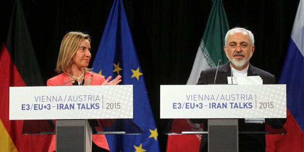 European Union High Representative for Foreign Affairs Federica Mogherini and Iranian Foreign Minister Mohammad Javad Zarif, from left, address the media after closed-door talks on the Iranian nuclear program in Vienna, Austria, Tuesday, July 14, 2015. (AP Photo/Ronald Zak)