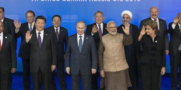 UFA, RUSSIA - JULY 10: In this handout image supplied by Host Photo Agency / RIA Novosti, President of the Russian Federation Vladimir Putin, centre, during a group photograph of BRICS leaders and the leaders of the invited states. From left: President of the Republic of Uzbekistan Islam Karimov, President of the Republic of Tajikistan Emomali Rakhmon, President of the Republic of South Africa Jacob Zuma, Prime Minister of the Islamic Republic of Pakistan Nawaz Sharif, President of the People's Republic of China Xi Jinping, President of Mongolia Tsakhiagiin Elbegdorj. From right: President of the Republic of Armenia Serzh Sargsyan, President of the Islamic Republic of Afghanistan Ashraf Ghani Ahmadzai, President of the Republic of Belarus Alexander Lukashenko, President of the Federative Republic of Brazil Dilma Rousseff, President of the Islamic Republic of Iran Hassan Rouhani on July 10, 2015 in Ufa, Russia. (Photo by Alexander Vilf / Host Photo Agency/Ria Novosti via Getty Images)