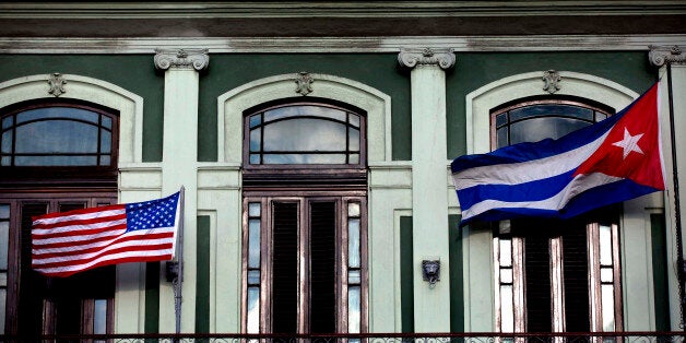 FILE - In this Jan. 19, 2015 file photo, a Cuban and American flag wave from the balcony of the Hotel Saratoga in Havana. President Barack Obama will announce July 1 that the U.S. and Cuba have reached an agreement to open embassies in Havana and Washington, a senior administration official said. (AP Photo/Ramon Espinosa, File)