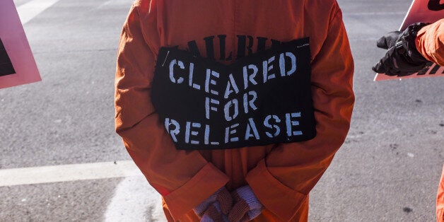 WASHINGTON, DC - JANUARY 10: Activists of Codepink and Witness Against Torture stage demonstrations in front of the CIA director John Brennan's house before protesting at CIA Headquarter in Washington on January 10,2015. The group of roughly 60 people, some of whom had been fasting in solidarity with prisoners at Guantanamo Bay, gathered on the eve of the anniversary of the controversial facilitys opening. (Photo by Samuel Corum/Anadolu Agency/Getty Images)