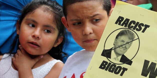 WASHINGTON, DC - JULY 09: Local politicians, human rights leaders and immigrant advocates gather to protest against billionaire Republican presidential candidate Donald Trump outside the Trump International Hotel, currently under construction on Pennsylvania avenue between the U.S. Capitol and the White House, July 9, 2015 in Washington, DC. Latino and Hispanic people were enraged when Trump disparaged immigrants and particularly Mexican-Americans while announcing his run for the presidency. Famous chef Jose Andres announced Wednesday that he will not longer open a Spanish restaurant in the hotel because of Trump's racist remarks. (Photo by Chip Somodevilla/Getty Images)