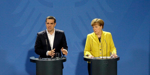 German Chancellor Angela Merkel, right, and the Prime Minister of Greece, Alexis Tsipras, address the media during a press conference as part of a meeting at the chancellery in Berlin, Germany, Monday, March 23, 2015. (AP Photo/Michael Sohn)