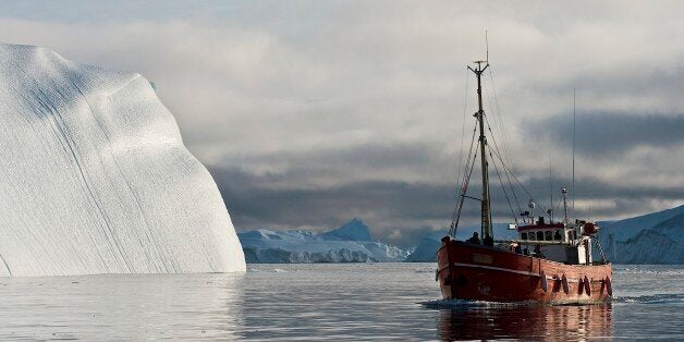 GREENLAND - AUGUST 02: Ship among the icebergs that have broken off the Sermeq Kujalleq ice sheet, Ilulissat, Qaasuitsup, Gre