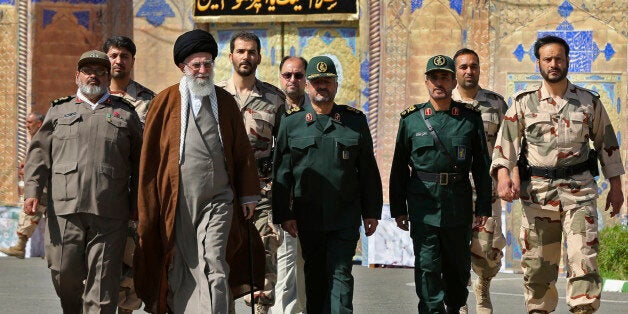 In this picture released by an official website of the office of the Iranian supreme leader on Wednesday, May 20, 2015, Supreme Leader Ayatollah Ali Khamenei, second left, attends a graduation ceremony of Revolutionary Guard officers in Tehran, Iran, as he is accompanied by Chief of the General Staff of Iran's Armed Forces, Hasan Firouzabadi, left, and Revolutionary Guard commander Mohammad Ali Jafar, center. Iran's supreme leader vowed Wednesday he will not allow international inspection of Iran's military sites or access to Iranian scientists under any nuclear agreement with world powers. (Office of the Iranian Supreme Leader via AP)