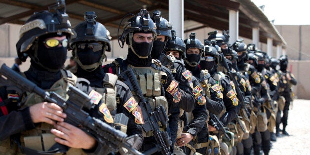 The Iraqi Counter Terrorism Service forces participate in a training exercise as U.S. Defense Secretary Ash Carter observes at its academy on the Baghdad Airport Complex in Baghdad, Iraq, Thursday, July 23, 2015. Carter is on a weeklong tour of the Middle East focused on reassuring allies about Iran and assessing progress in the coalition campaign against the Islamic State in Syria and Iraq. (AP Photo/Carolyn Kaster, Pool)