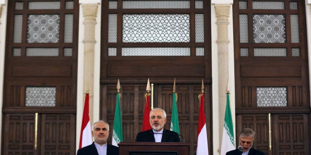 Iranian Foreign Minister Mohammad Javad Zarif, center, speaks during a press conference at the government palace in Beirut, L