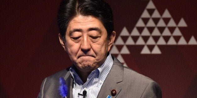 Japan's Prime Minister Shinzo Abe reacts during the economic forum Japan Summit 2015 in Tokyo on July 9, 2015. Abe on July 9 addressed a Tokyo forum hosted by the Economist magazine, while attempting to boost the economy and trying to push a set of controversial defence bills. AFP PHOTO / KAZUHIRO NOGI (Photo credit should read KAZUHIRO NOGI/AFP/Getty Images)