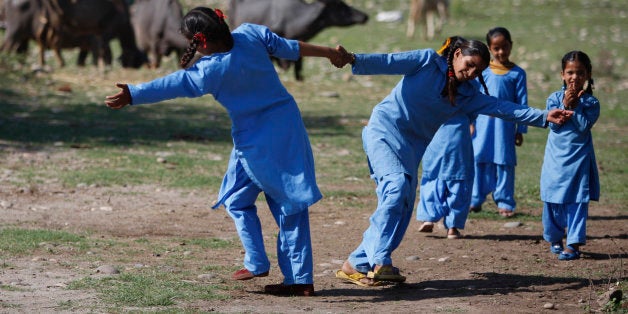 Young Indian children play before classes begin at their government-run school on the outskirts of Jammu, India, Thursday, April 9, 2015. According to the UNESCO Education for All Global Monitoring Report 2015, two out of three countries where lower secondary education was not compulsory in 2000 had changed their legislation by 2012, including India, Indonesia, Nigeria and Pakistan. According to the report, rural India saw substantial improvement in nearly all aspects of school facilities and infrastructure between 2003 and 2010. (AP Photo/Channi Anand)