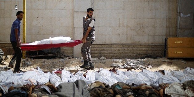 DAMASCUS, SYRIA - AUGUST 16: Bodies of Syrians seen after Assad regime forces vacuum bomb air-strike staged to a marketplace inside residential areas in Douma Town of East Ghouta region of Damascus, Syria on August 16, 2015. Casualties reported after strike. Vacuum bomb is a type of explosive that utilizes oxygen from the surrounding air to generate an intense, high-temperature explosion. (Photo by Motasem Rashed/Anadolu Agency/Getty Images)