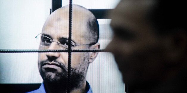 TRIPOLI, July 28, 2015 -- This file photo taken on April 27, 2014 shows Saif al-Islam Gaddafi on trial via video-conference software in a courtroom in Zintan, Libya. A Libyan court on Tuesday sentenced Saif al-Islam Gaddafi, son of the former leader Muammar Gaddafi, to death, according to local judicial resources. (Xinhua/Zhang Yuan via Getty Images)