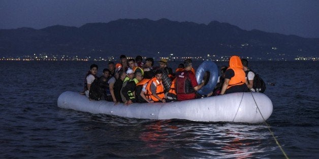 Migrants travel on an inflatable boat to reach the Greek island of Kos as Turkish coast guards (not pictured) try to stop the
