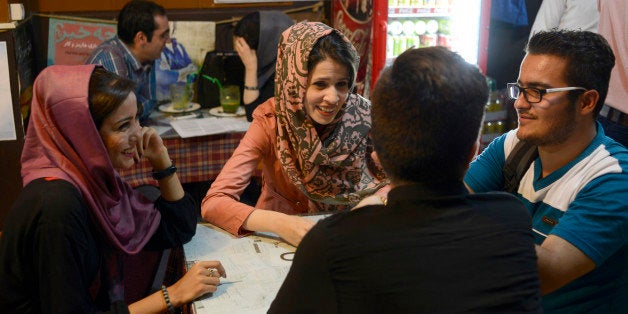 TEHRAN, IRAN - MAY 10, 2015: Iranian youth socialize while sat in a coffeeshop located near the university on Revolution Stre