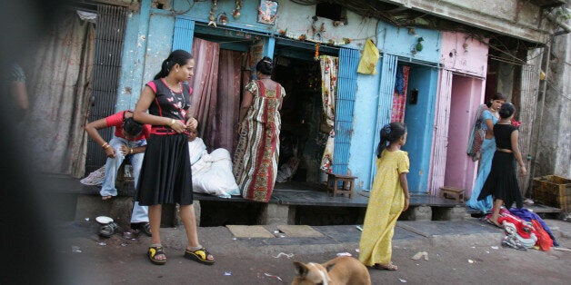 Sex workers stand on a road to attract customers at a red light district in Bombay, in the western Indian state of Maharashtr