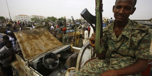 TO GO WITH AFP STORY BY TOM LITTLEA fighter from the Sudanese Rapid Support Forces sits on a vehicle in the city of Nyala, in south Darfur, on May 3, 2015, as they display weapons and vehicles they say they captured from Dafuri rebels and fighters from The Justice and Equality Movement (JEM), lead by opposition leader Jibril Ibrahim, the previous week. Darfur's insurgency was launched in 2003, with the rebels complaining of economic and political marginalisation by the Arab-dominated government in Khartoum. Bashir unleashed a brutal counter-offensive using Arab militia and the military. The United Nations says the conflict has killed 300,000 and forced 2.5 million from their homes. AFP PHOTO / ASHRAF SHAZLY (Photo credit should read ASHRAF SHAZLY/AFP/Getty Images)