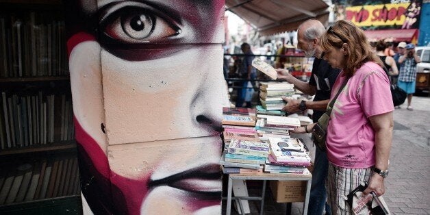 People look at second-hand books on sale at an Athens flee market on August 23, 2015. Greek opposition parties try to form a