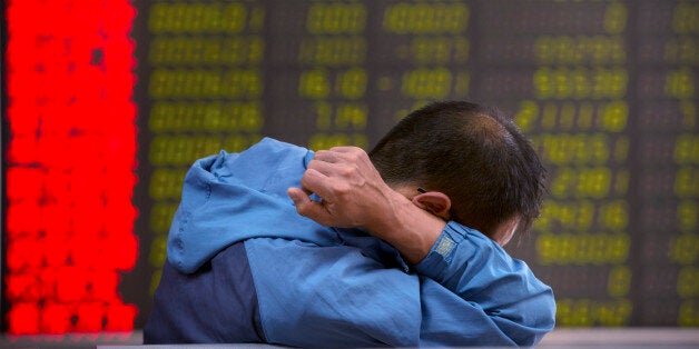 A Chinese investor monitors stock prices at a brokerage house in Beijing, Tuesday, Aug. 25, 2015. China's main stock market index has fallen for a fourth day, plunging 7.6 percent to an eight-month low. (AP Photo/Mark Schiefelbein)