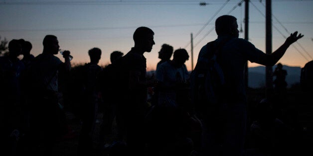 Syrian refugees wait at the border railway station of Idomeni, northern Greece, in order to be allowed by the Macedonian police to cross the border from Greece to Macedonia, Monday, Aug. 24, 2015. Thousands of migrants have arrived on Greek islands so far this year, hoping to head north to other more prosperous European countries such as Germany, the Netherlands and Scandinavian countries. (AP Photo/Santi Palacios)