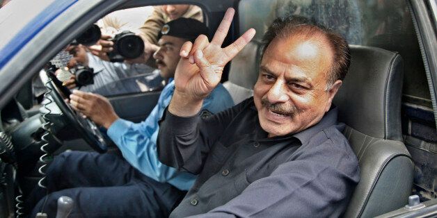 PAKISTAN - NOVEMBER 04: Hamid Gul, former general in the Pakistan Armed Forces, sits in a police van after his arrest in Islamabad, a day after Pervez Musharraf, Pakistan's president, declared a state of emergency, on Sunday, Nov. 4, 2007. Musharraf asked for more time to restore full democracy, without committing to a date for national elections, after imposing emergency rule for the second time since his 1999 military coup. (Photo by Asad Zaidi/Bloomberg via Getty Images)
