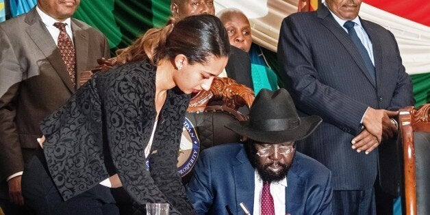 South Sudan's President Salva Kiir (C) signs a peace agreement in the capital Juba, on August 26, 2015. The deal is designed to end 20 months of civil war, but Kiir also issued a list of 'serious reservations' warning the deal might not last. The signing ceremony, held in the capital Juba in the presence of regional leaders, came hours after the UN Security Council threatened immediate action if Kiir failed to put his name to the accord, which has already been signed by rebel leader Riek Machar. South Sudan's civil war erupted in December 2013 when Kiir accused his former deputy Machar of planning a coup, sparking a cycle of retaliatory killings that has split the country along ethnic lines. Some 200,000 people displaced by the fighting are sheltering at UN bases, while hundreds of thousands more have fled the country. AFP PHOTO/ CHARLES LOMODONG (Photo credit should read CHARLES LOMODONG/AFP/Getty Images)