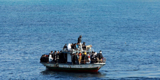 A boatload of would-be migrants believed to be from North Africa is seen moments before being rescued by the Italian Coast Guard in the waters off the Sicilian island of Lampedusa, Italy, Sunday, Feb. 13, 2011. By dawn Saturday, around 3,000 migrants fleeing turmoil in North Africa had arrived by boat on Lampedusa over three days, hundreds more arrived during the day and several more boats were reportedly spotted on the horizon headed for the flat-rock, largely barren fishing island, Italian authorities said. (AP Photo/Daniele La Monaca)