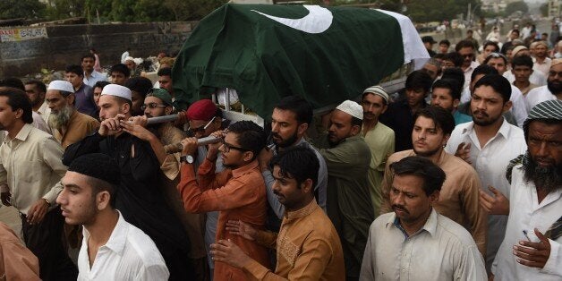 Pakistani mourners carry the coffin of Mehmood Hussain Niazi in Karachi on August 31, 2015, following an attack by gunmen on the Jiwani airport in the district of Gwadar. Gunmen armed with automatic weapons early August 30 attacked a small airport in Pakistan's remote and restive southwest, killing an officer and abducting another, officials said. Up to a dozen attackers torched navigation equipment at Jiwani airport in Gwadar district before entering the building, a spokesman for Pakistan's Civil Aviation Authority (CAA) said. AFP PHOTO/ Asif HASSAN (Photo credit should read ASIF HASSAN/AFP/Getty Images)