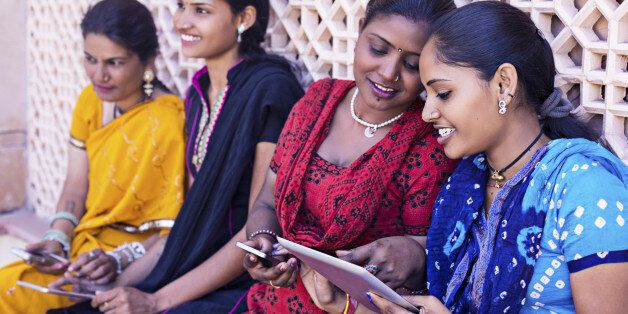 Indian women having sharing and talking with their digital devices.